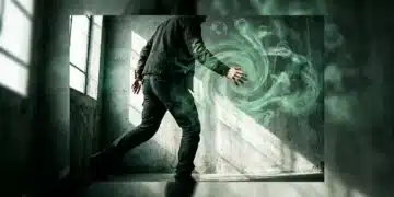 A person's hand reaching into a swirling green mist with cultural and technological projections, symbolizing the blend of creativity, culture, and future trends.